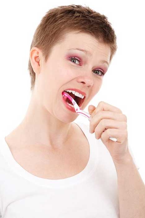 Woman brushing her teeth